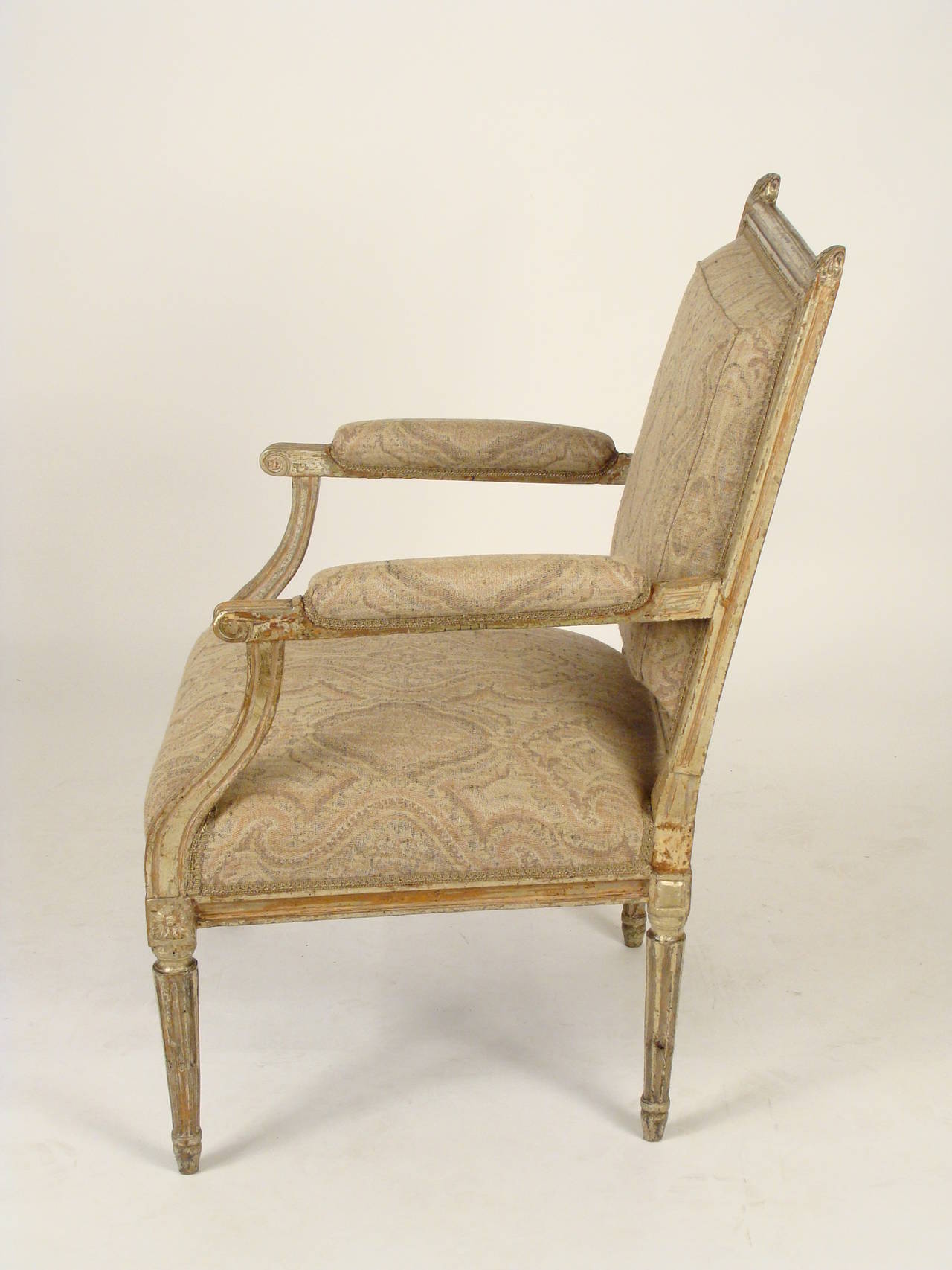 Louis XVI style silver leaf and painted open armchair, 19th century.
