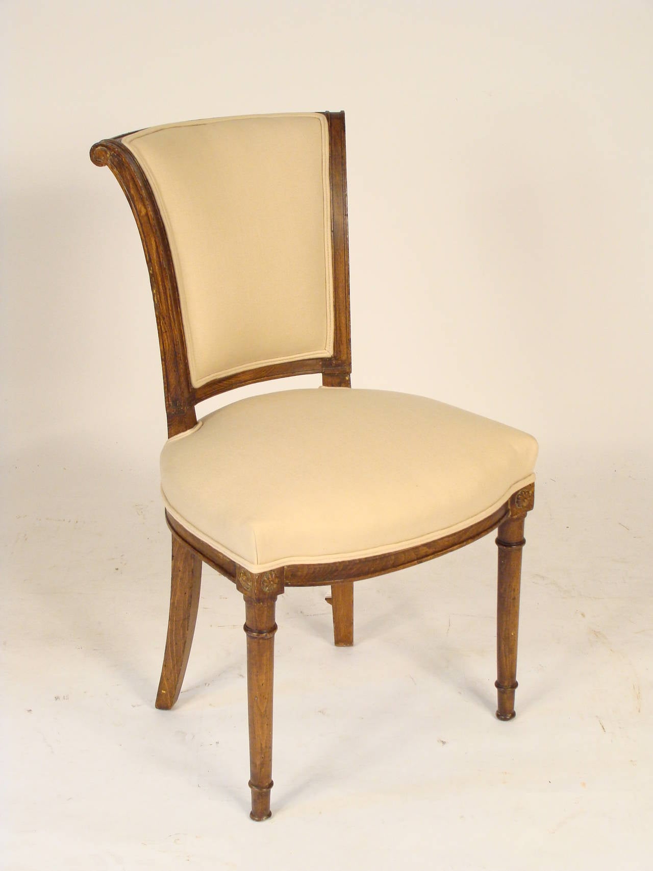 Set of six Directoire style beech wood dining room chairs, circa 1910. These chairs have nice clean lines that would compliment either a neoclassical or contemporary interior. All of the chairs of have been taken apart and re glued so that they are