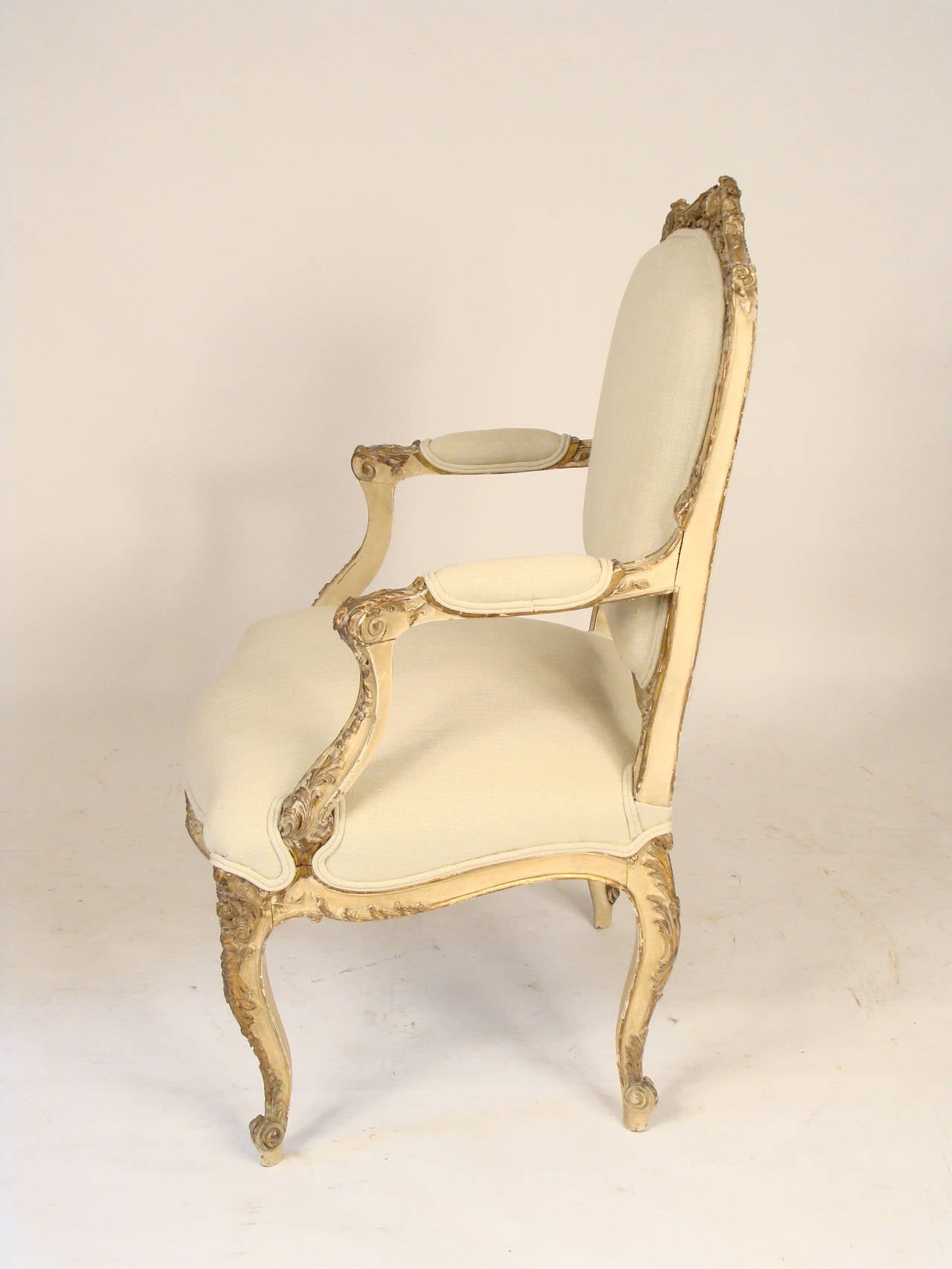 Louis XV style painted, gilded and carved open armchair, late 19th century. Nice old worn paint and very fine quality foliate carving.