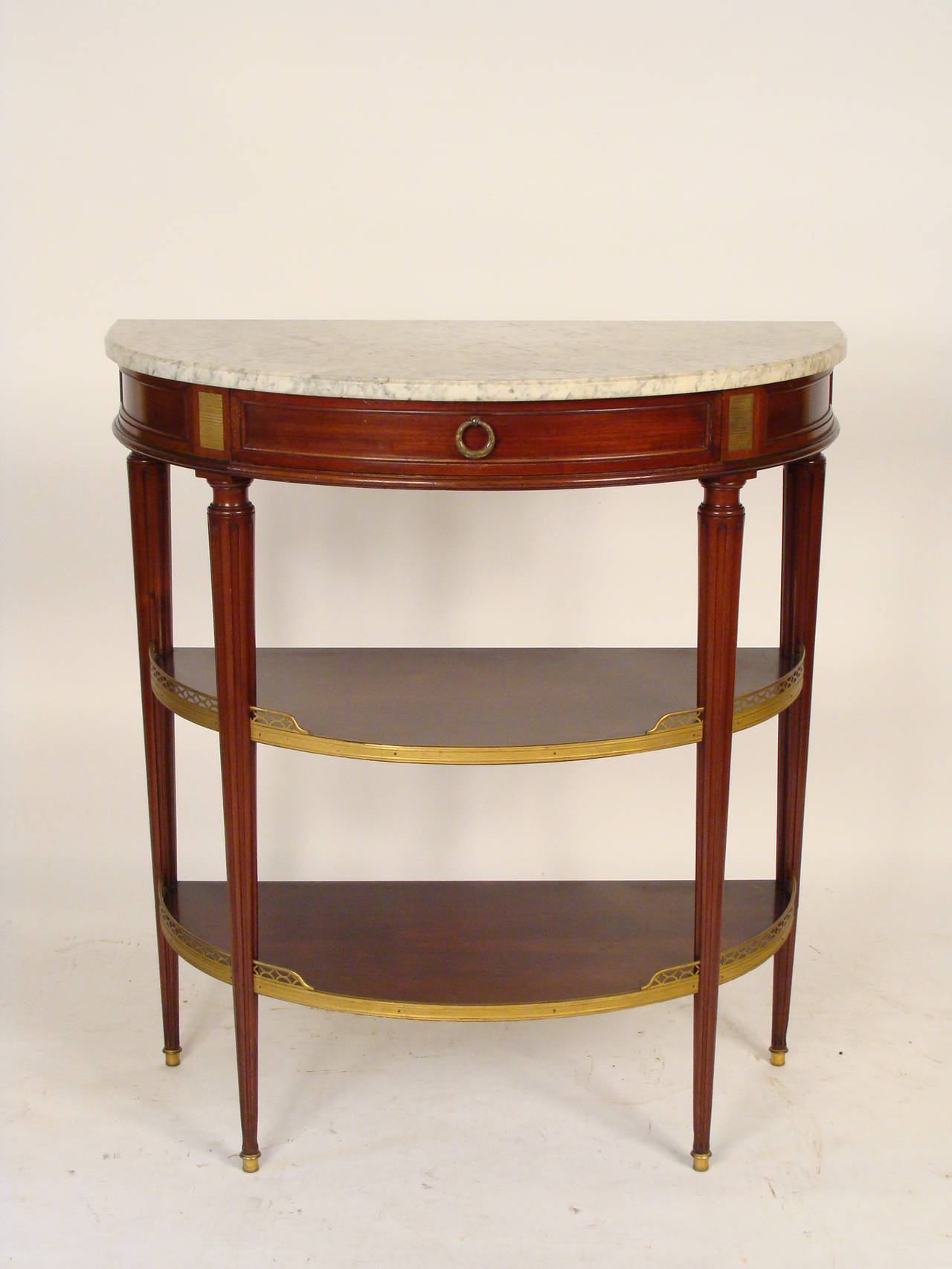 Louis XVI style mahogany brass-mounted marble-top console table, in the style of Maison Jansen, circa 1930.