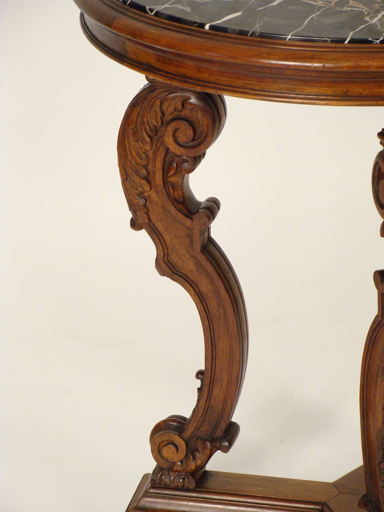 Louis XIV style carved walnut occasional table with a Belgium marble top, circa 1920.