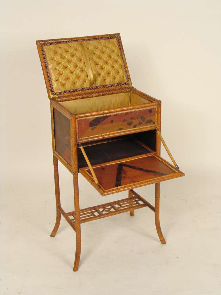 Edwardian bamboo and lacquered occasional or work table. The bamboo frame was probably made in England and the lacquered plaques were imported from the orient.