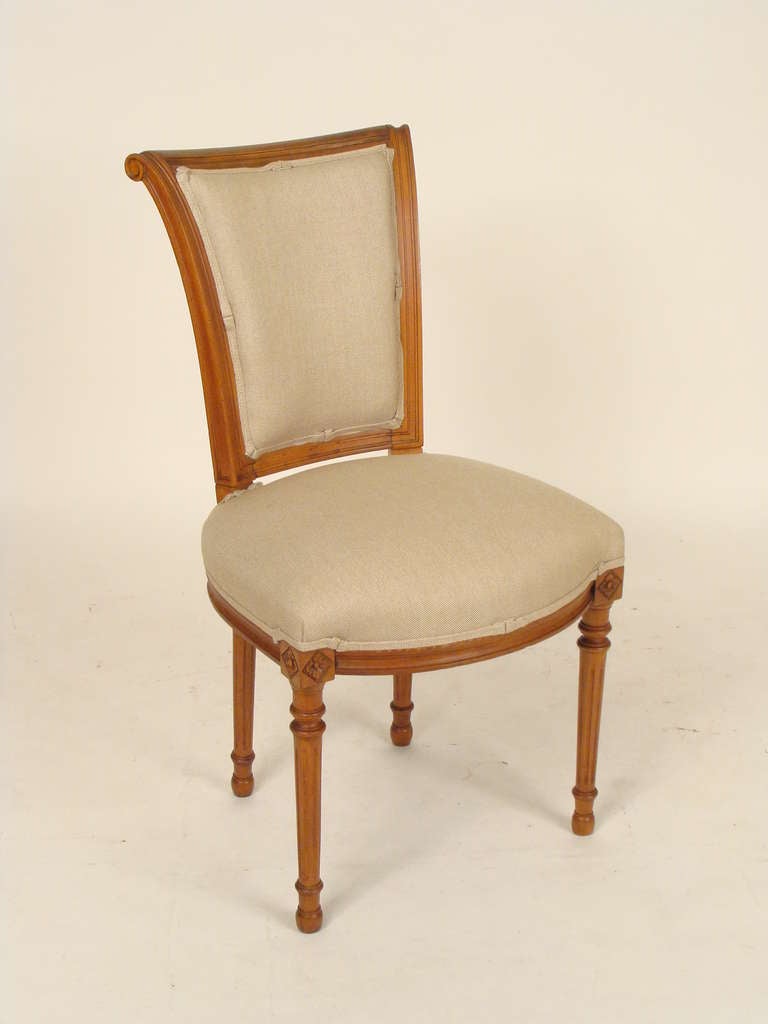 Set of 6 Directoire style beech wood dining room chairs, circa 1930. These chairs have  nice color, scrolled crest rails and fluted legs. Each chair has been completely taken apart the old glue removed and then reassembled. The frames are as tight