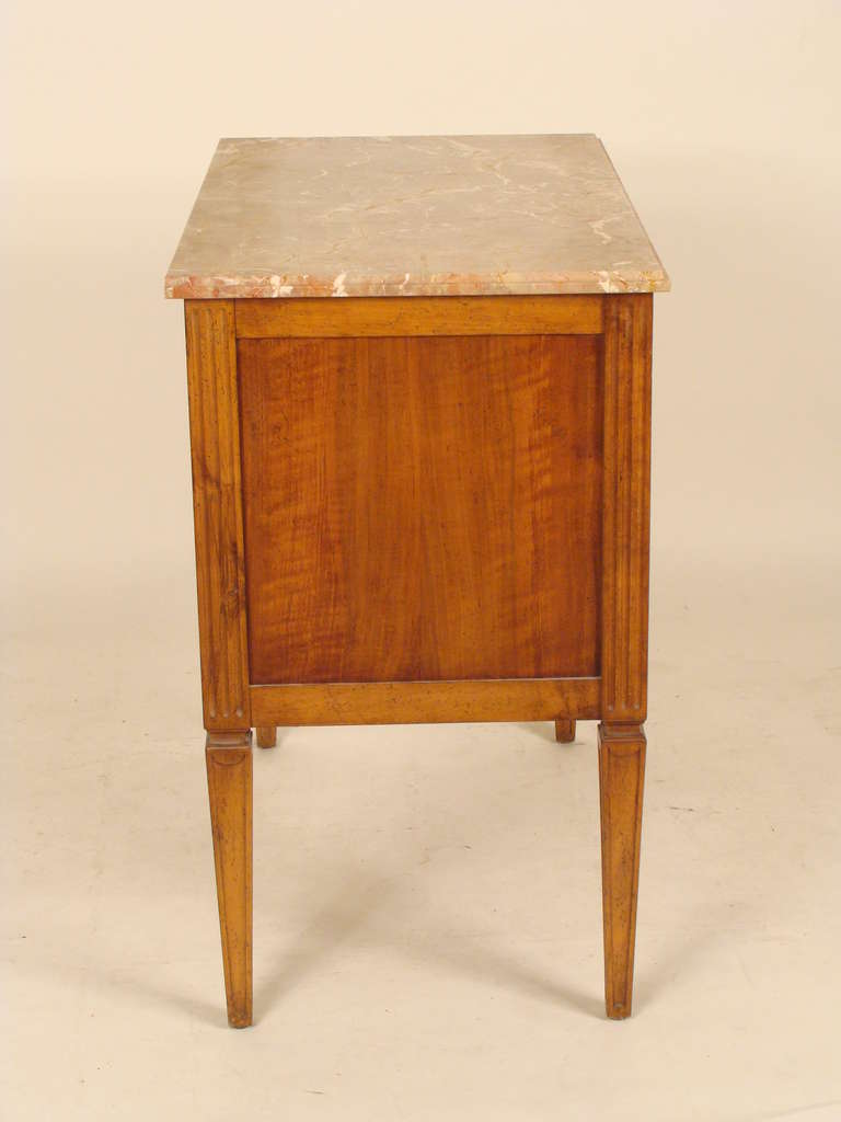 Louis XVI style inlaid chest of drawers with a marble top, approximately 35 years old.