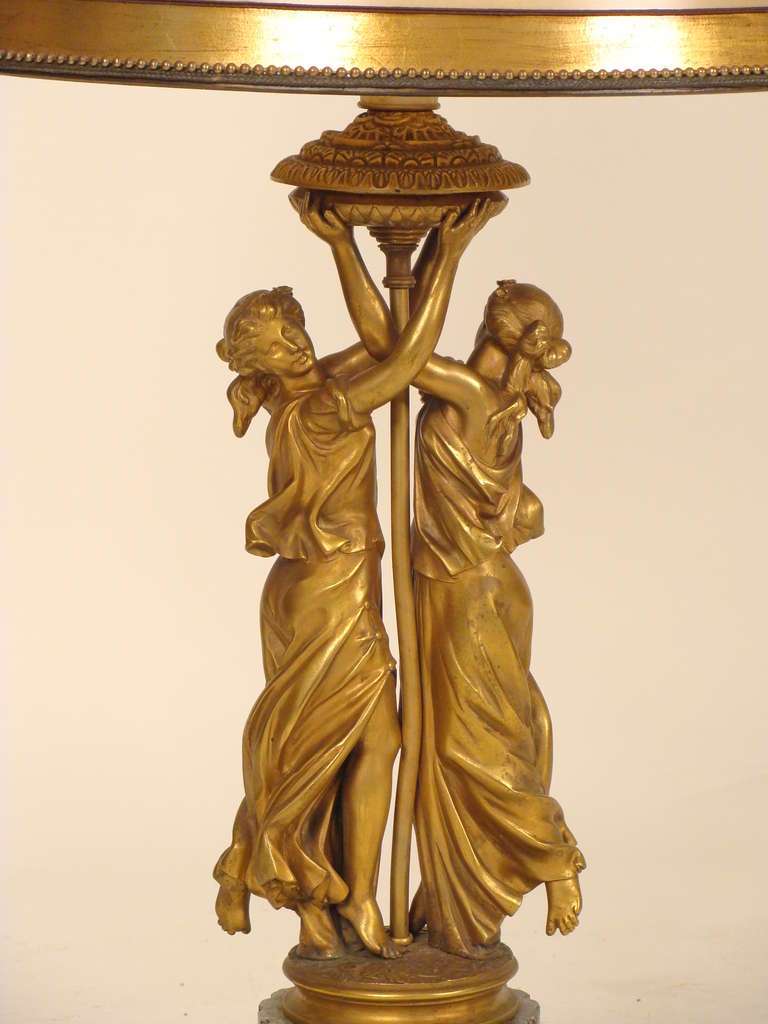 Neoclassical style gilt bronze figural table lamp with a marble base, circa 1900. The height to the top of the shade is 33.5