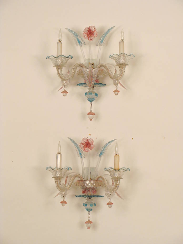 Pair of Murano glass two-light wall sconces, mid-20th century. These wall sconces are very colorful and would brighten up any room in which they are placed. Please note one wall sconce is missing a leaf.