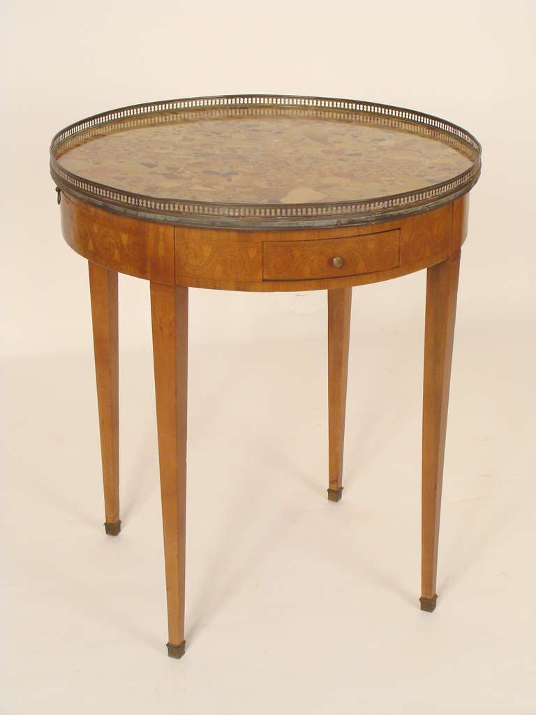 Louis XVI style inlaid bouillotte table with a breche de alep marble top, circa 1920.