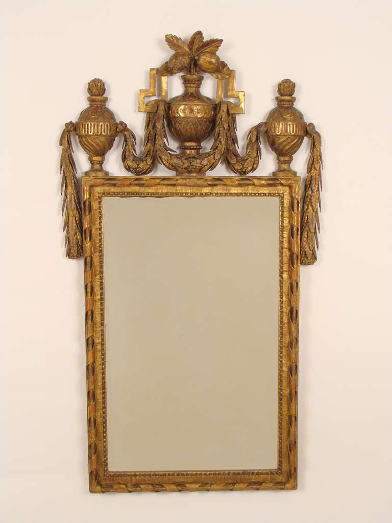 Neoclassical style giltwood mirror, with robust carved urns and swags, late 19th century.