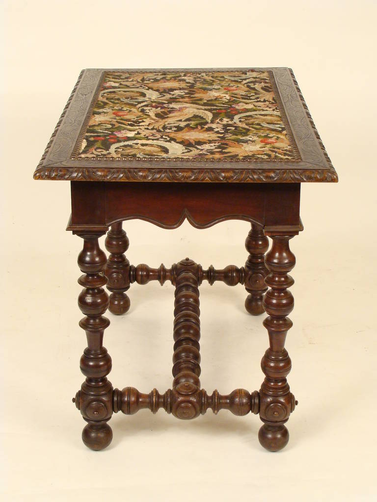 Louis XIV style occasional table with a needlepoint top, 19th century. This table has very robust turnings.