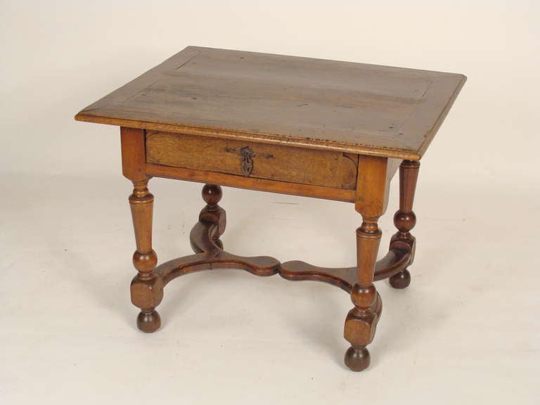 Antique Continental Louis XIV style walnut and oak single drawer occasional table, 19th century.