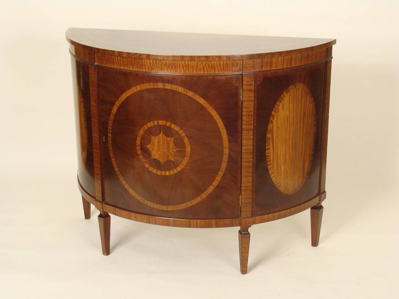 George III style mahogany demi lune cabinet with satinwood inlay made by Baker, the Charleston collection ,approximately 25 years old.