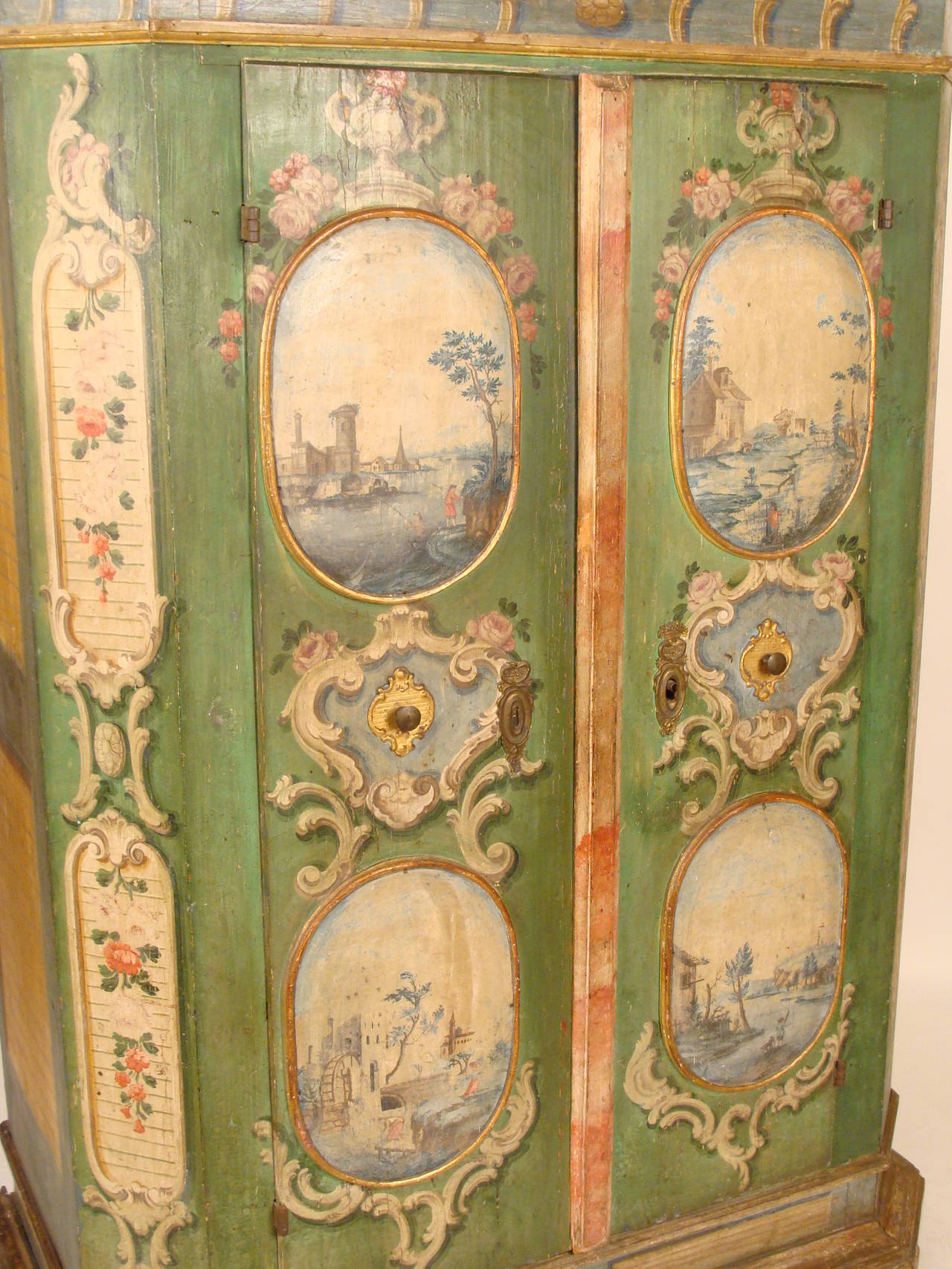 Louis XIV style continental painted armoire, 19th century. This is a very colorful painted armoire featuring two doors with four cartouche framed Capriccio scene paintings.