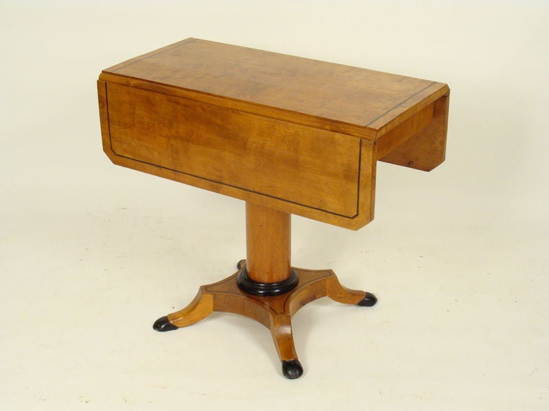 Biedermeier style birch and ebonized drop leaf table, early 20th century.Please note the length when opened is 35 1/4