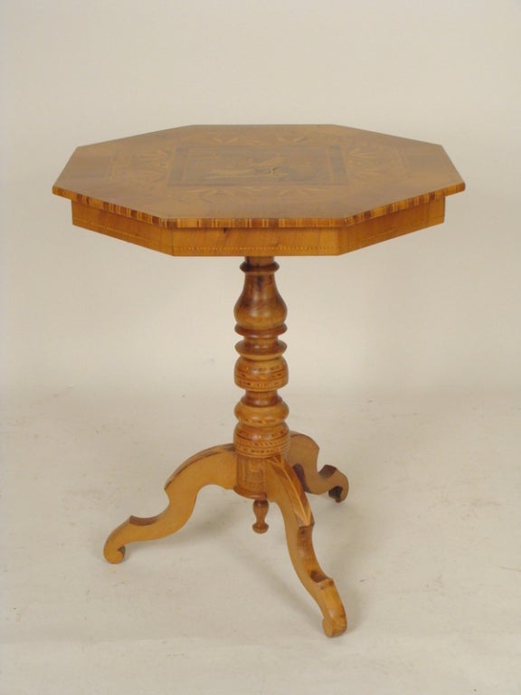 Italian inlaid table with an octagonal shaped top resting on a tripod base, circa 1920