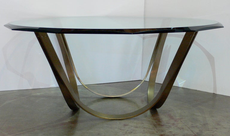 Architectural bronze finished coffee table by Roger Sprunger for Dunbar.  Twelve-sided beveled glass top.