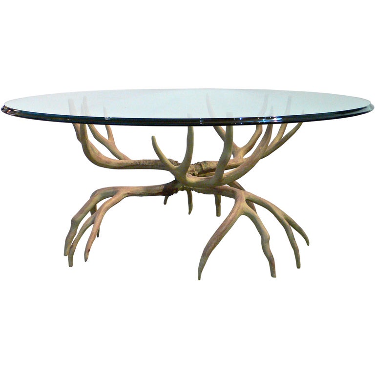 Realistic antler table cast from aluminum. Surprisingly light yet extremely strong and stable. Glass size is 39.5 inches diameter.