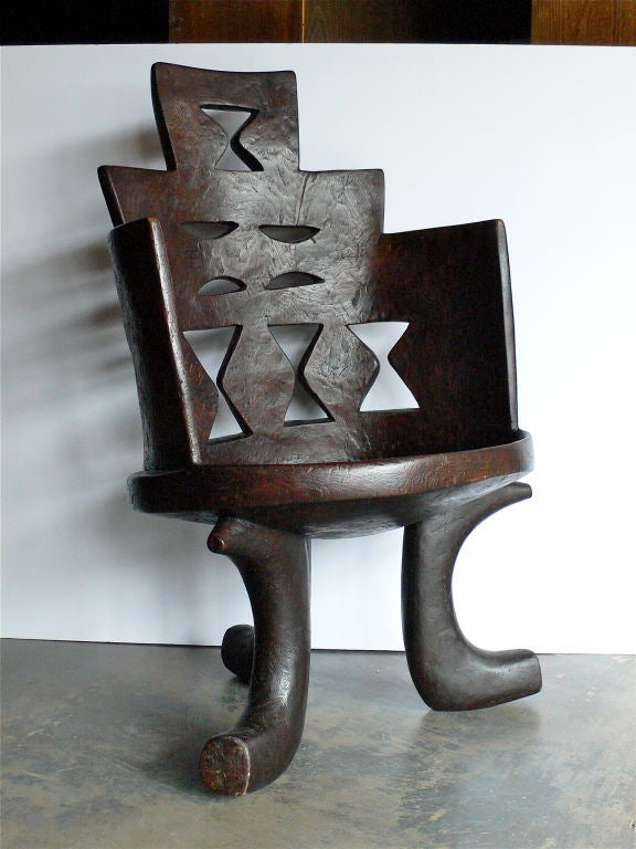 Vintage high back Ethiopian chair. Unusually large format with superb cut out motifs. These seats were designated for a highly regarded individual in the tribe.