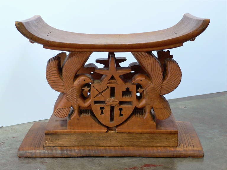 Large, vintage Ashanti stool carved from one piece of hardwood.
Showing the Heraldic emblem of Ghana, home of the powerful Ashanti Empire.

At the bottom of the stool, 
