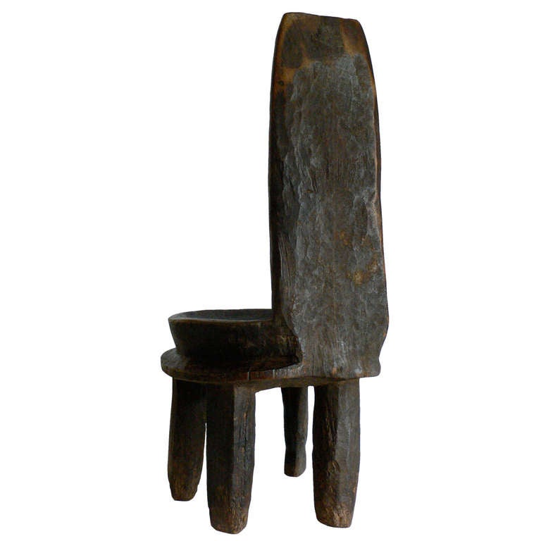 An early Ethiopian high back chair carved from one piece of iron wood. Unusual six-leg format.