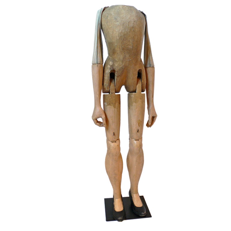 Hand-carved and painted wood puppet with fabric arms, jointed knees and hips, high heeled black shoes. On later stand. Illegible signature. Great piece of early American folk art.

Provenance: Balthrop Collection, Tim Hill Collection