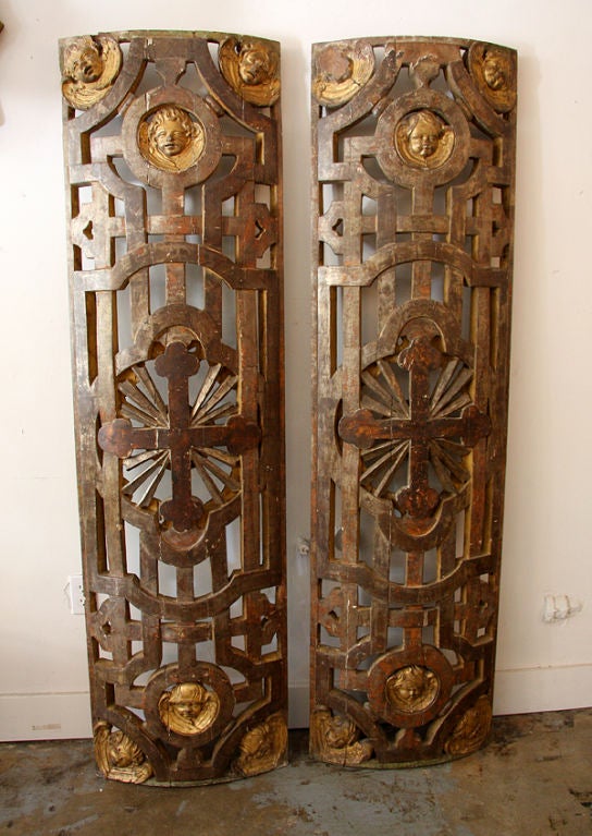 A single, exceptionally carved wood panel from a church in Italy featuring gilded, cherub faces. NOTE: One of these two panels has sold. The remaining piece is now mounted on a custom, iron base.