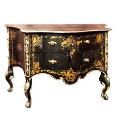 A Rococo two-drawer commode with gilded decorations