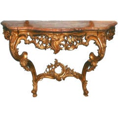A gilded wood console table (tavolo da muro) with a marble top