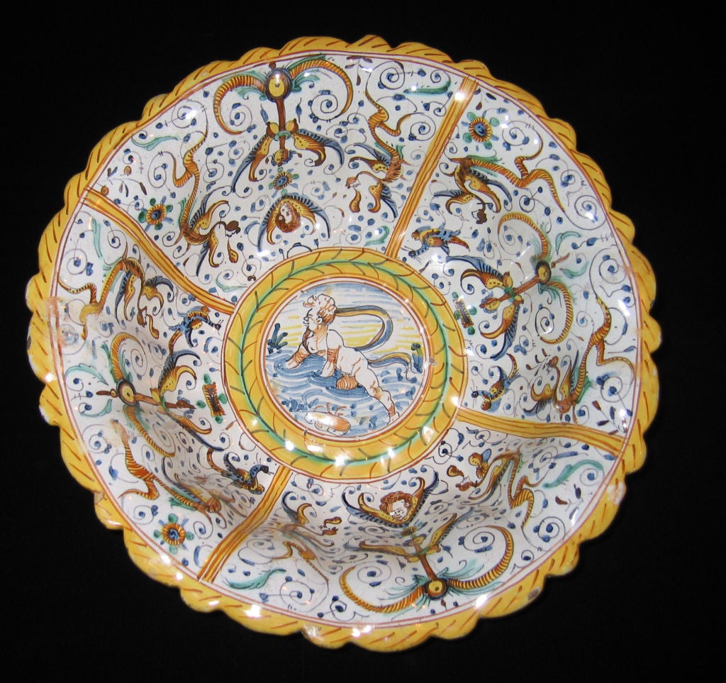 A Large Lobed Earthenware Bowl With Grotesque Decorations