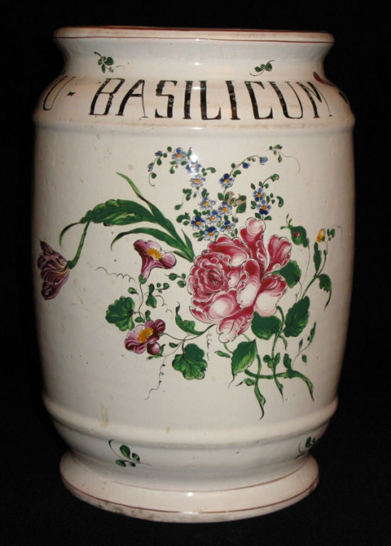 A large majolica apothecary jar for essence of basil with rose, forget-me-nots, and morning glory decoration.