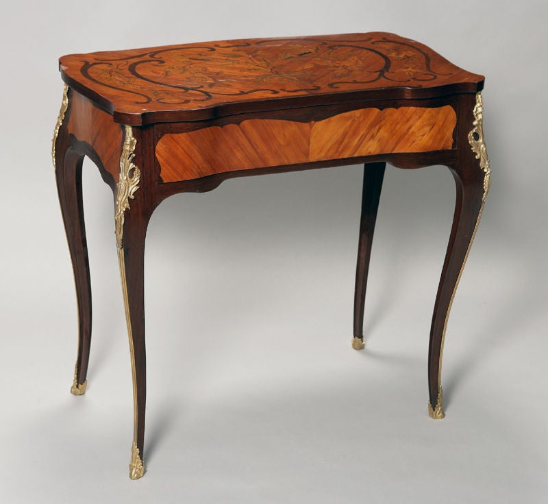 Stamped: Pierre Macret (1727–1796, active 1756–1785)<br />
<br />
Pierre Macret was a royal artisan circa 1758. Macret fabricated numerous small, ingenious pieces of furniture, tables with pull-outs, work tables, gueridons, tripods, and