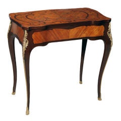 A marquetry table with gilt bronze mounts and secret drawer open