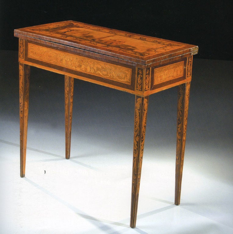 An inlaid and veneered wood Neoclassic games table with maple, palissander, walnut, and mahogany woods on a bois de rose veneered base. This card table has the typical structure of an 18th century neoclassic, north Italian game table from the same