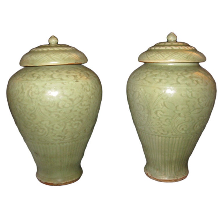 A pair of celadon porcelain vases and covers For Sale