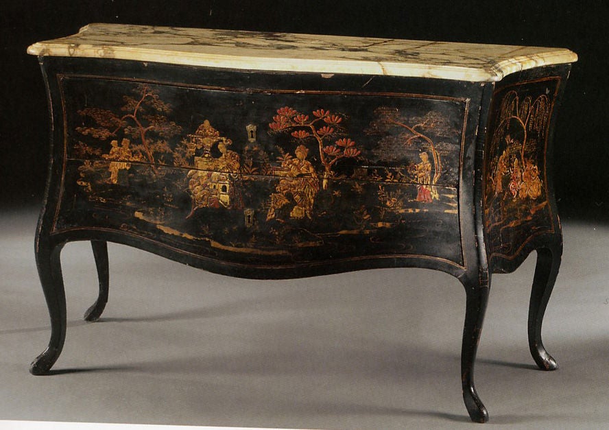 A very rare chinoiserie lacquered á Balestra two-drawer commode (without traverse)<br />
above cabriolé legs with pad feet, with gold and red chinoiserie figural decoration set amidst a fantastical landscape of trees, foliage and pagodas.  With its