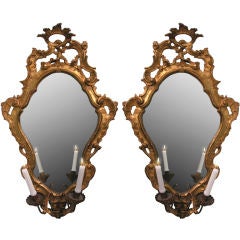 A pair of carved and gilded wood girandole mirrors
