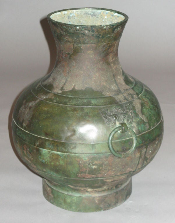 Patinated bronze vase with two ring handles