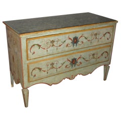 A pale blue painted two-drawer commode with polychrome paint