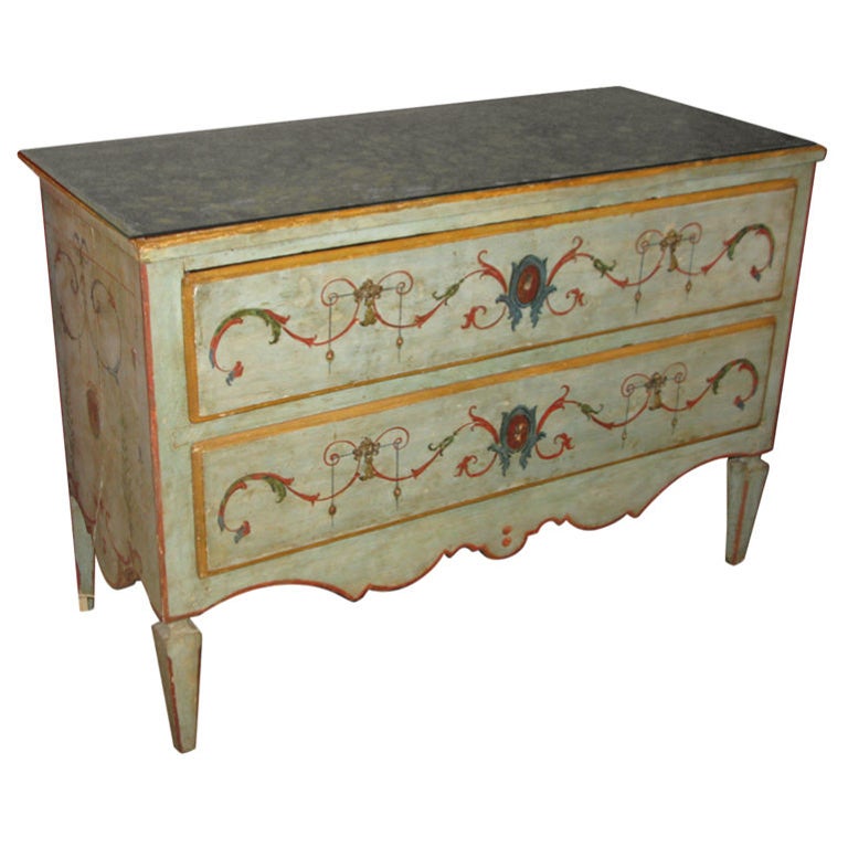 A pale blue painted two-drawer commode with polychrome paint