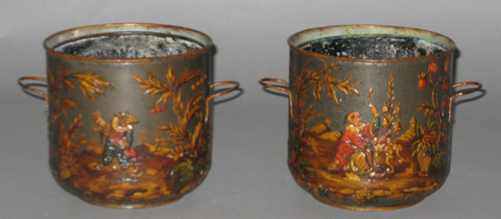 A pair of tôle cachepot with handles; decorated on all sides with painted and gilt Chinoiserie motif.