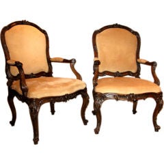 A very fine pair of carved walnut armchairs