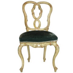 A very finely carved and painted cream side chair