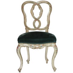 A very finely carved and painted white side chair