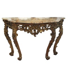 An Italian carved and gilded console with marble top