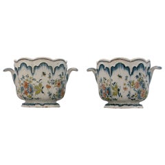 A pair of glazed earthenware cachepots