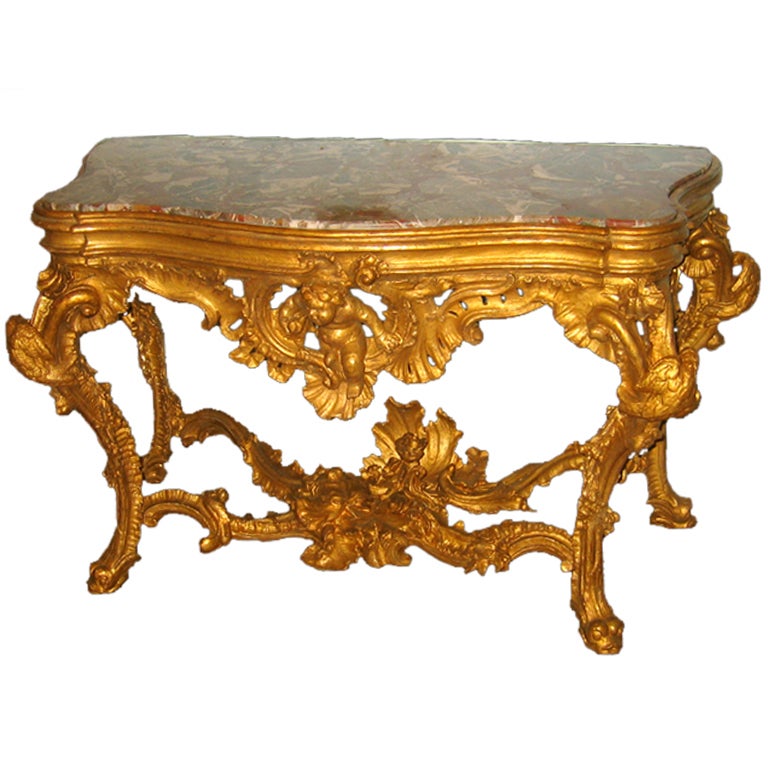 An Elaborately Carved And Gilded Console Table For Sale