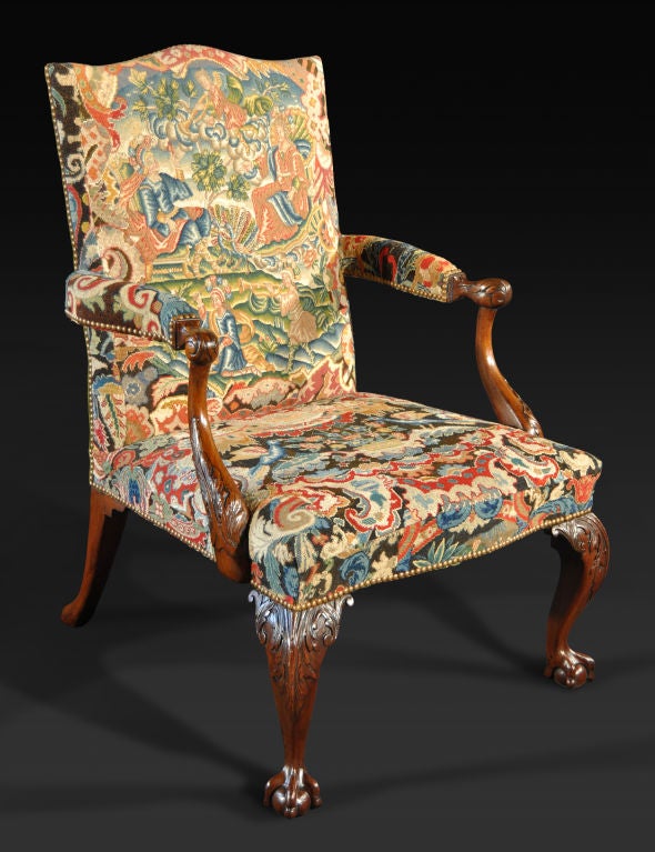 The rectangular back with serpentine crest rail upholstered in period gros- and petit-point needlework depicting a classical scene incorporating the goddess Juno attended by a peacock, and issuing padded outswept armrests; raised on front