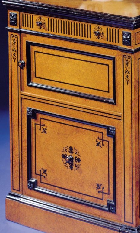 The molded top above a shallow frieze drawer, over a cupboard and deep drawer.