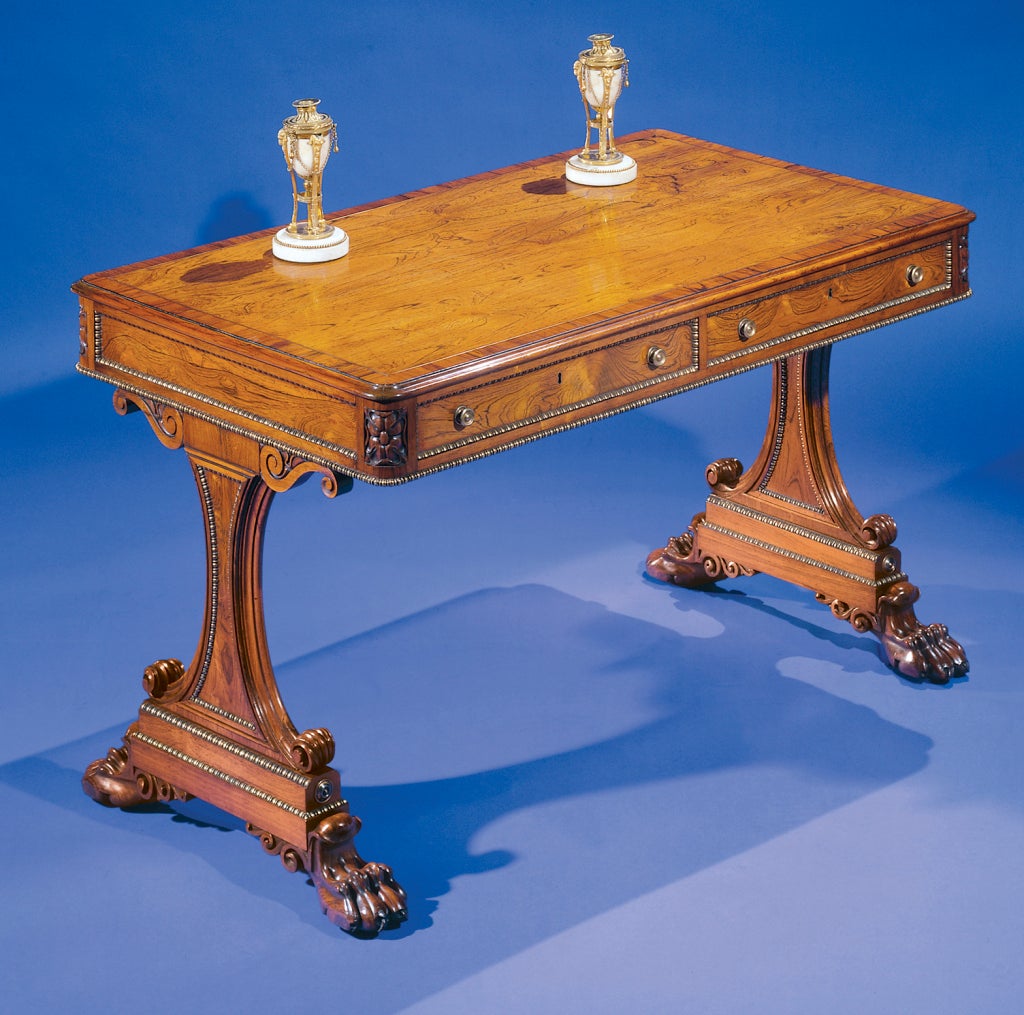 Mounted with brass beading throughout; the two drawer frieze above scroll-carved supports ending in bold paw feet.