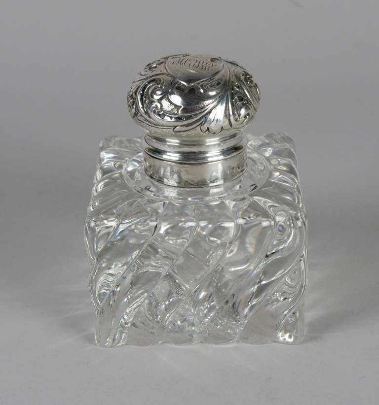 Large crystal and sliver mounted inkwell, the hinged top with a monogrammed shield within a repousse leaf design; the molded body with swirling lobes. The mark is for George Sheibler and Co., New York, which operated from 1876-1910.

This gorgeous