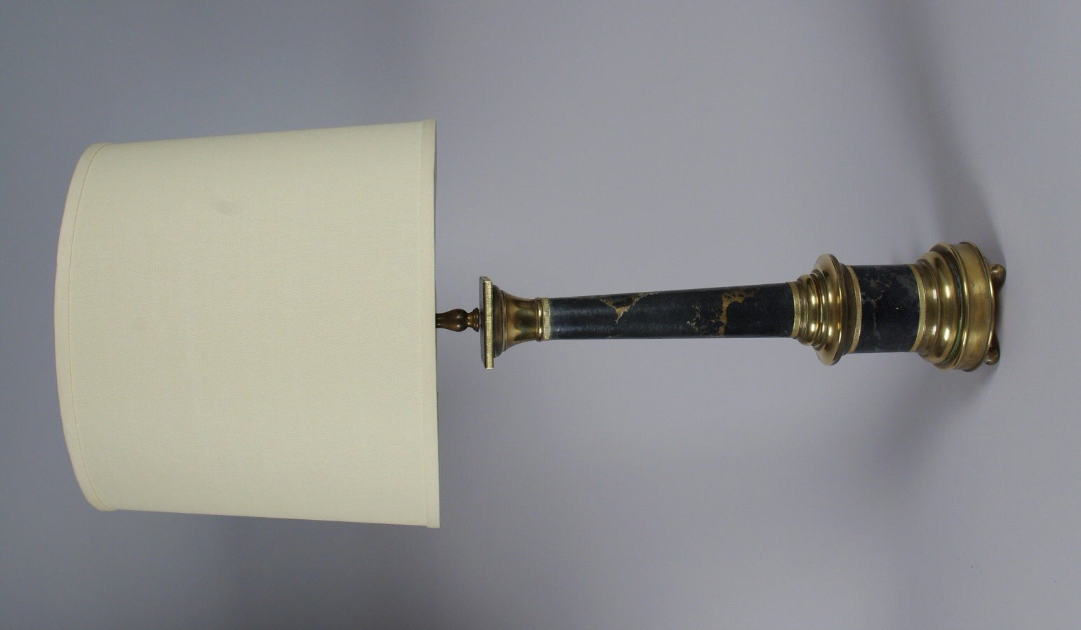 Wonderful brass column lamp trimmed with marbleized and gilt paper, on three ball feet.
Height to the top of the column, 20